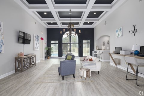 A modern living room with a grey sofa and a wooden floor.
